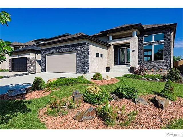 67 Portside Dr. Professionally landscaped. Stone & stucco exterior, triple pane windows, stainless steel accents