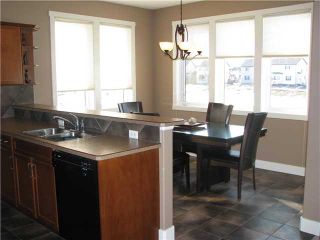 Photo 9: 317 LUXSTONE Green SW: Airdrie Residential Detached Single Family for sale : MLS®# C3468529