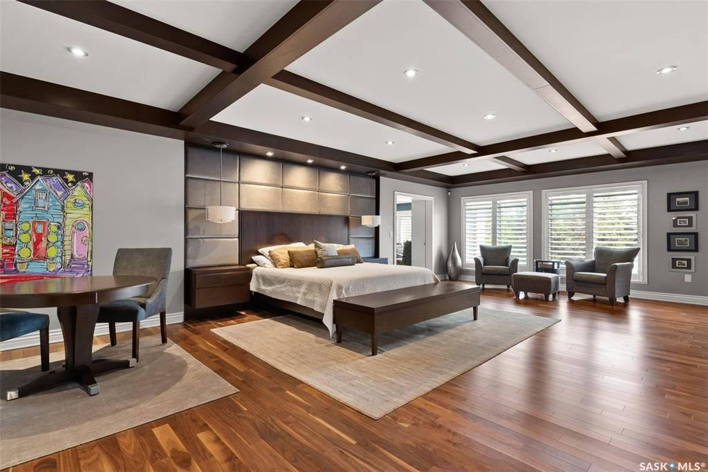 Bedroom featuring coffered ceiling and hardwood flooring.