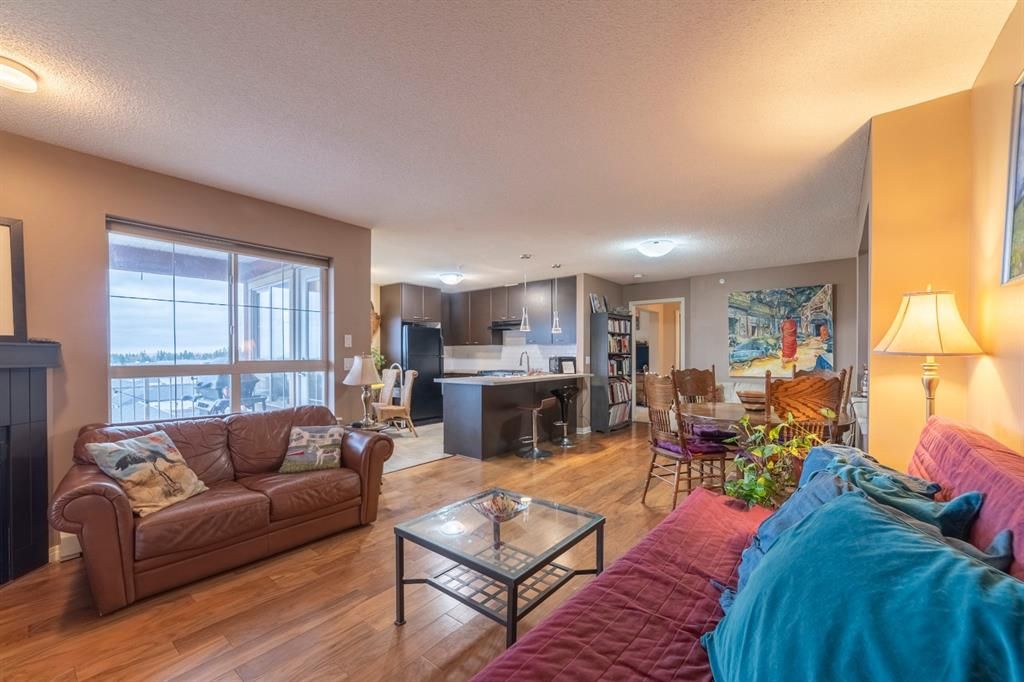 Open concept Living room - full sized unlike other apartments - with Fireplace and comfortable to spend time looking out at the view or entertaining guests securely