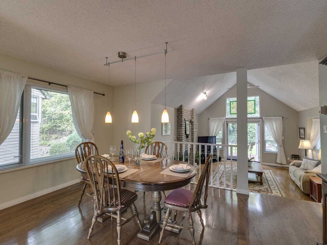 Dining room overlooking vaulted, sunken living room with access to wrap around deck.