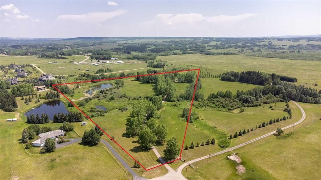 20.39 acres with a creek and pond, a wide variety of natural trees and vegitation, mature landscaping, wildlife, privacy and just minutes to Calgary. A great place to create an amazing estate with horses or possibly a private pitch and putt golf course.