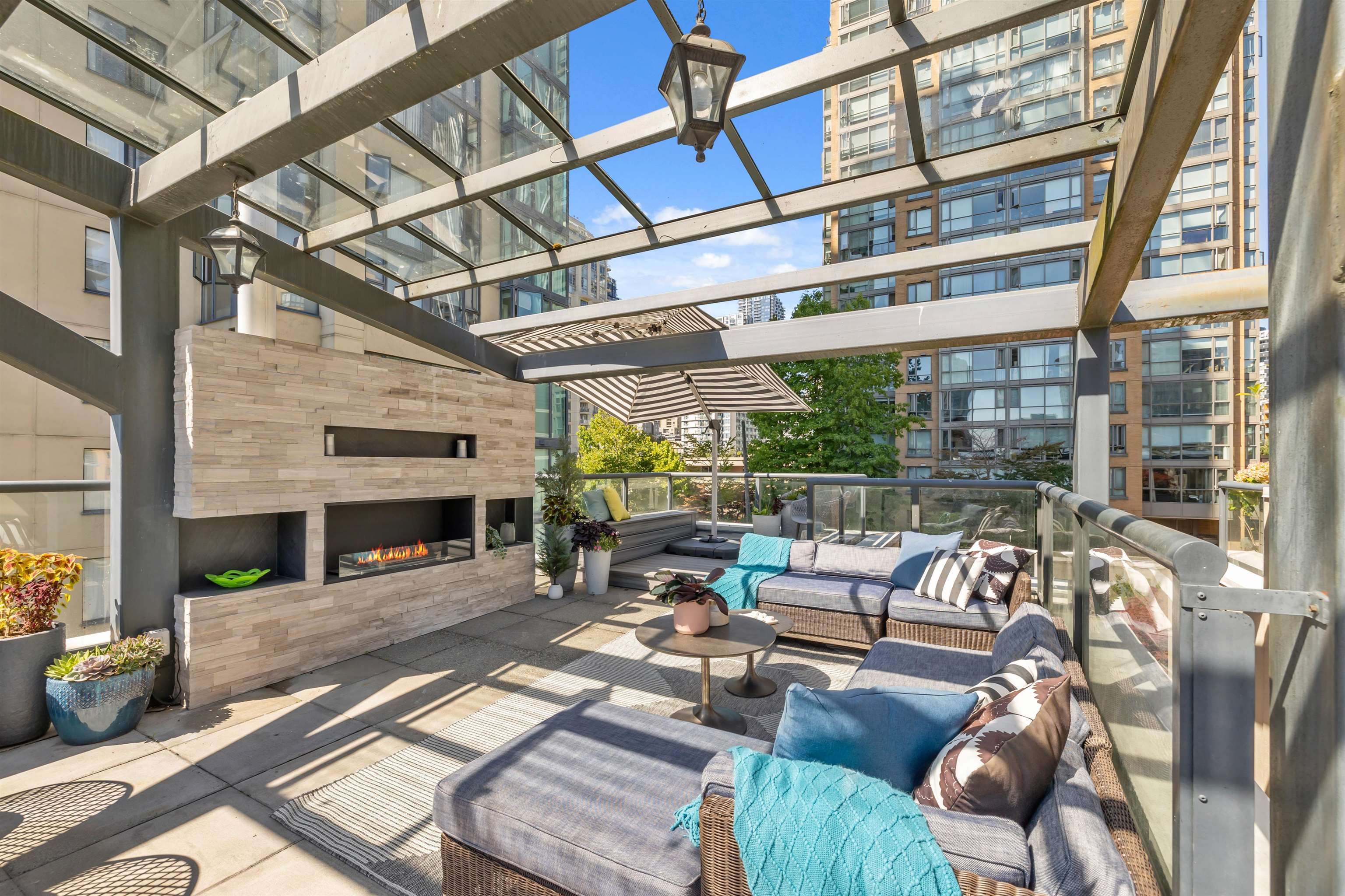 612 sf. Private rooftop patio fully equipped with outdoor kitchen, fireplace and multiple seating areas.