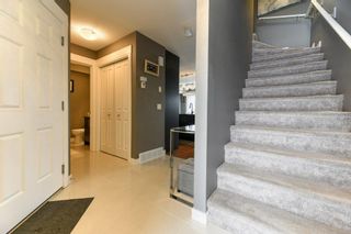 Photo 3: 11 West Coach Manor SW in Calgary: West Springs Row/Townhouse for sale : MLS®# A2035861