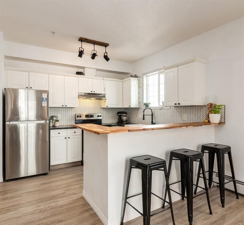 Gorgeous recently renovated kitchen has tons of texture and feels luxurious.