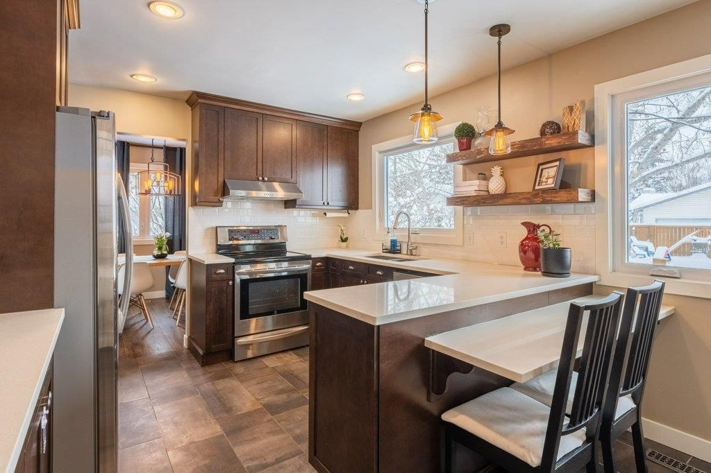 Kitchen -- its ALL renovated / replaced. Quartz countertops, stainless steel appliances, tot he ceiling cabinets, attractive open shelving