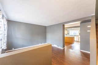 Photo 2: 321 Queenston Heights SE in Calgary: Queensland Row/Townhouse for sale : MLS®# A1201430