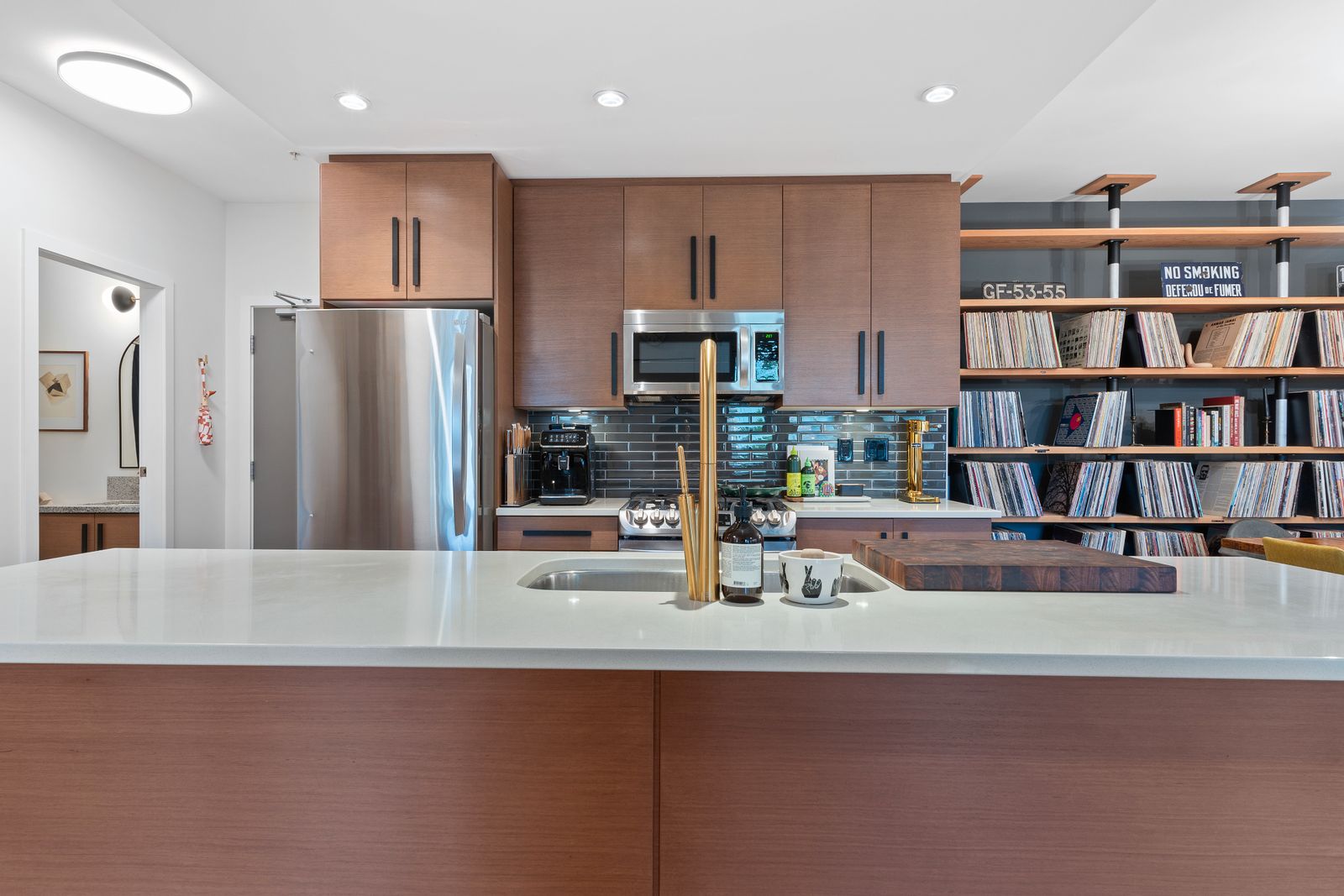 Kitchen with white countertops, brown wood cupboards, and stainless steel appliances.