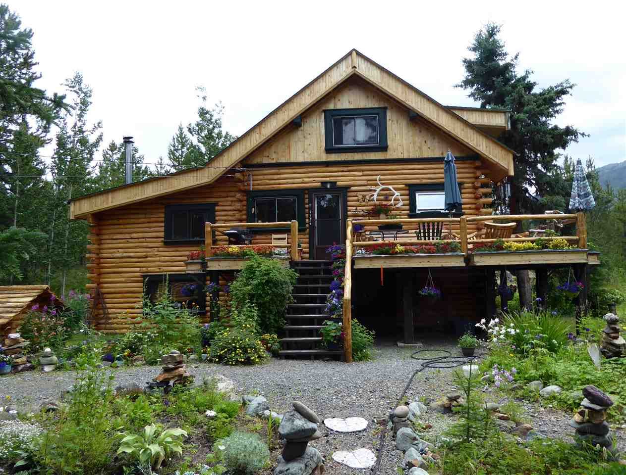 Beautiful log home tucked way back in the trees, backing onto Pine Creek and with a great landscaped yard with underground irrigation