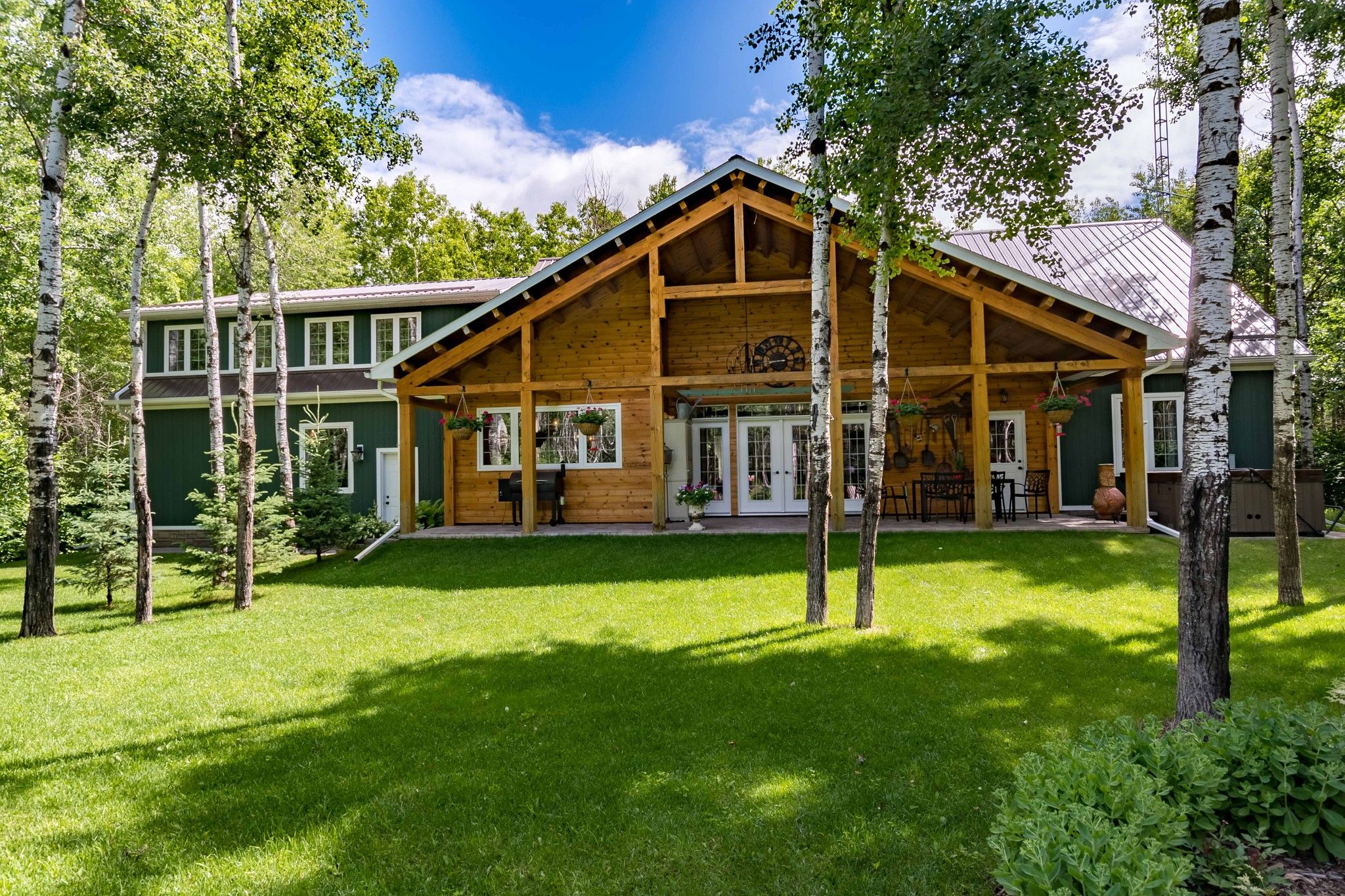 PRIDE OF OWNERSHIP! Meticulously maintained 2500 sf 3 bedroom bungalow (2011), with metal roof, vaulted timber frame covered 40x12 patio, 25x24 AT2, fantastic 40x36 Workshop on a beautifully  landscaped mature treed 5 acre lot.