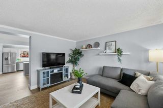 Photo 3: 563 Queenston Gardens SE in Calgary: Queensland Row/Townhouse for sale : MLS®# A2126181