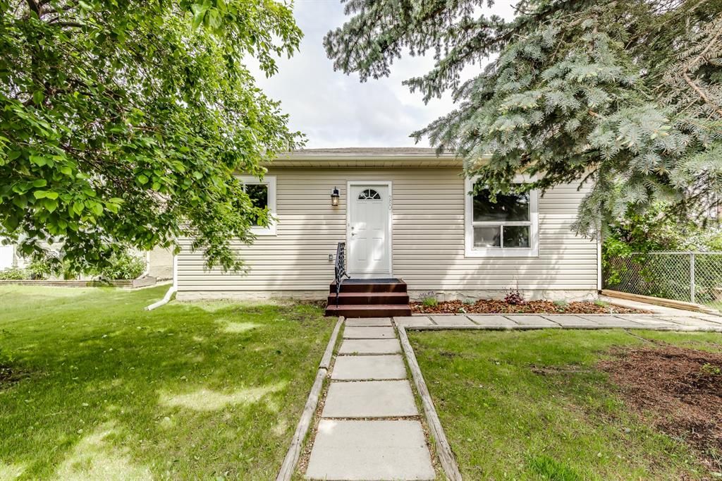 Welcome home to this charming bungalow on a quiet street with mature trees and brand new siding and updated windows!