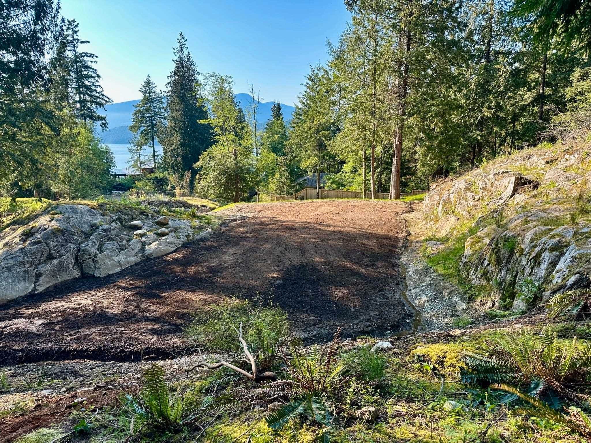 A large, flat build site nestled between exposed granite features enjoys sunset views and a western exposure. Power, water, Telus and Shaw utilities are live directly at the build site ready for you to dream, design and build.