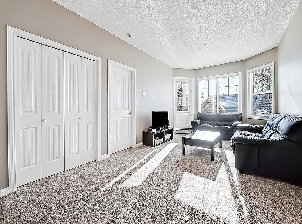 Main Photo: 207 8 Prestwick Pond Terrace SE in Calgary: McKenzie Towne Apartment for sale : MLS®# A2027991