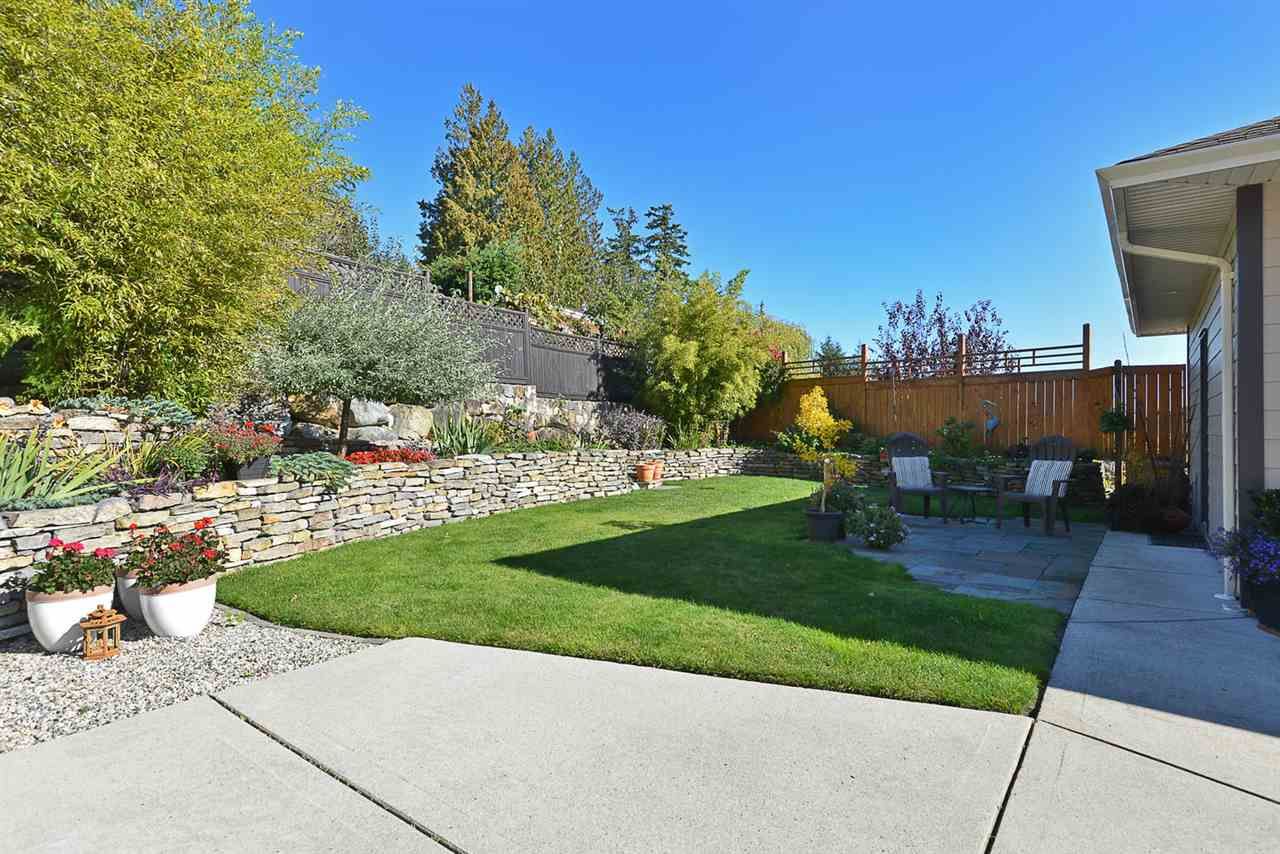 Simply immaculate!  Check out the rock wall, yellow cedar fence, landscaped with vegetable and flower gardens.   Private and quiet for cooling down on those hot summer evenings.