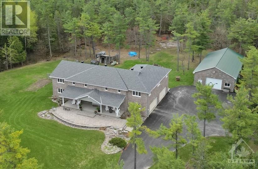 Aerial view of stately home and workshop sitting on a beautiful and serene 4 acre lot in the small town gem of Almonte.