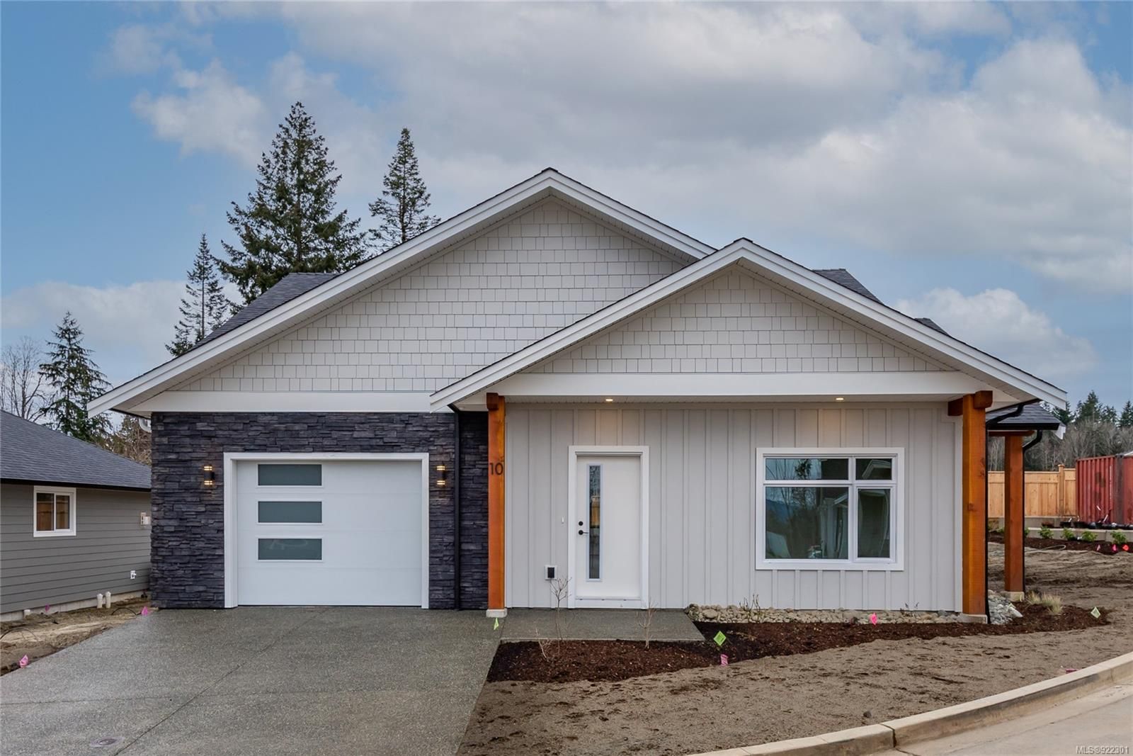 This end unit has stunning cedar posts, with a mixture of board and batten, shake and stacked stone exterior finishes. Also double wide driveway, landscaping, irrigation, fencing and rear patio.