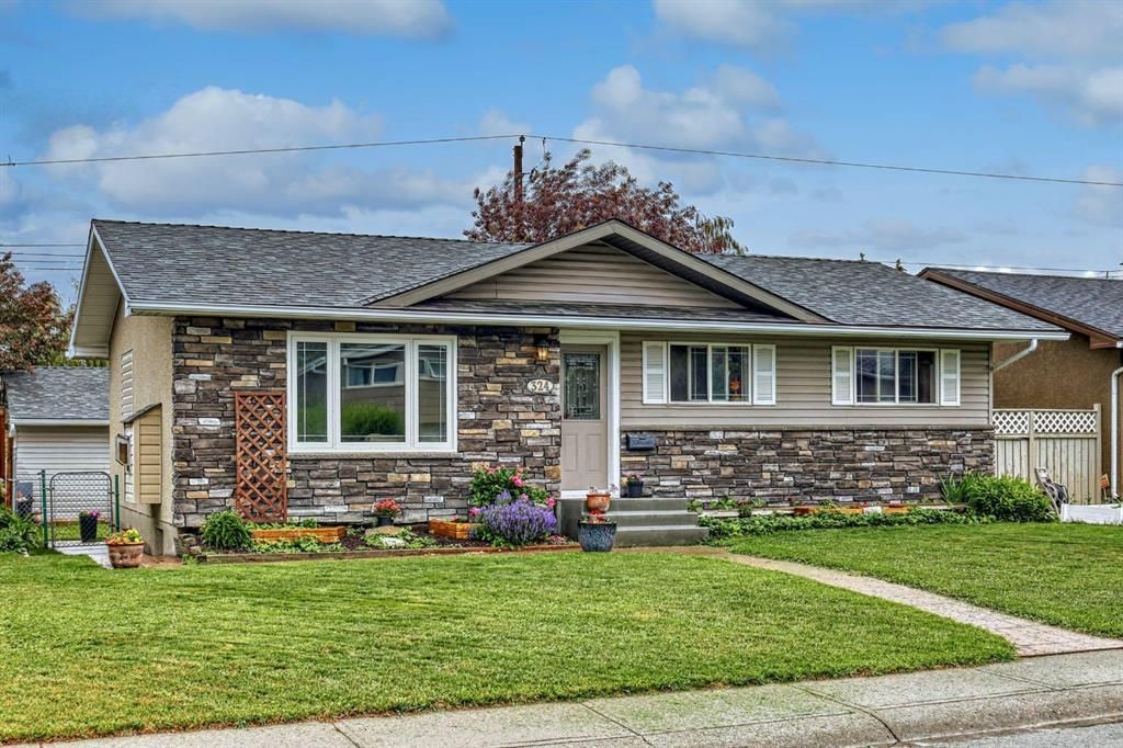 Well maintained lawn and garden.  Stone work on the front along with vinyl siding makes the home so appealing.