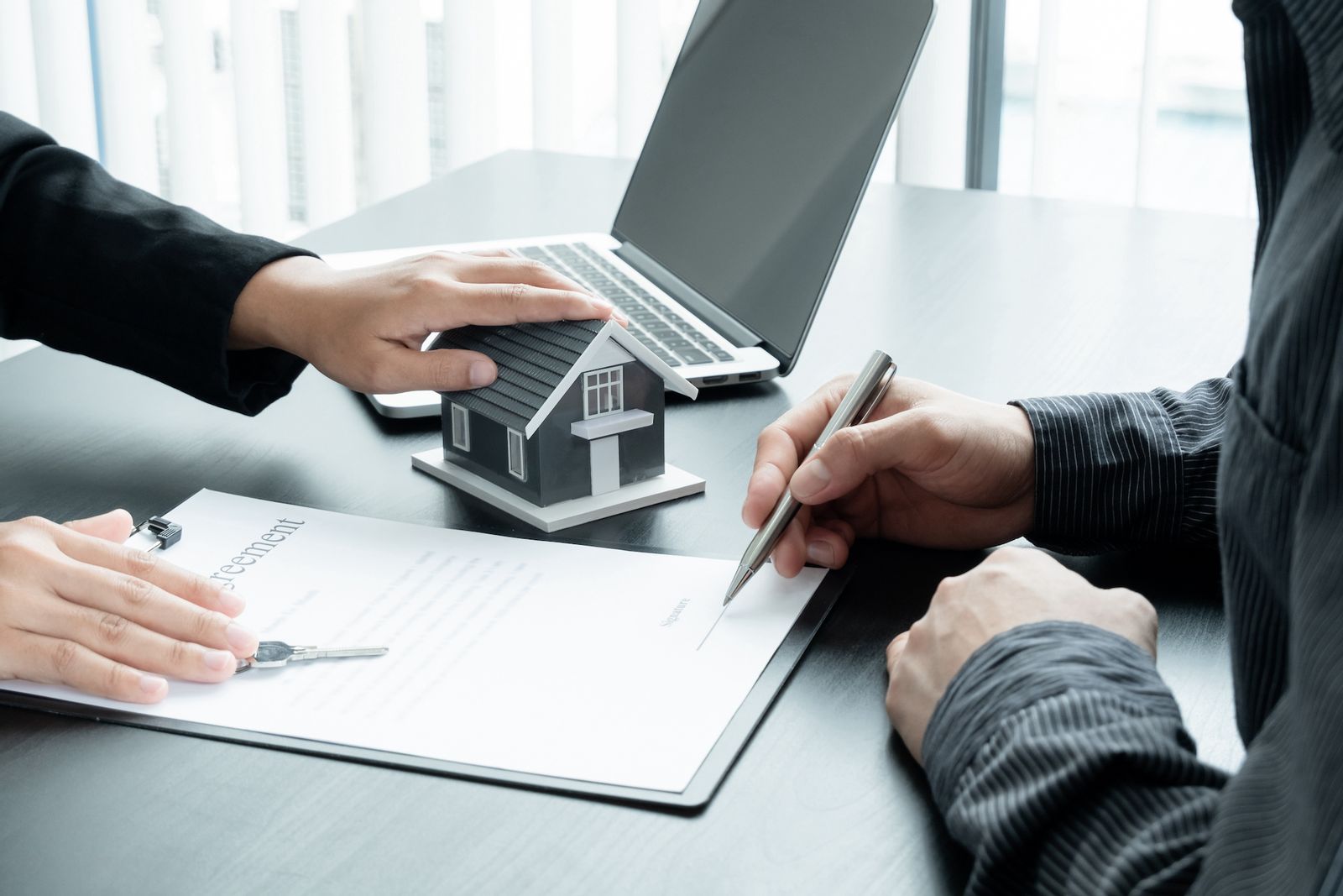 Real estate sellers signing paperwork