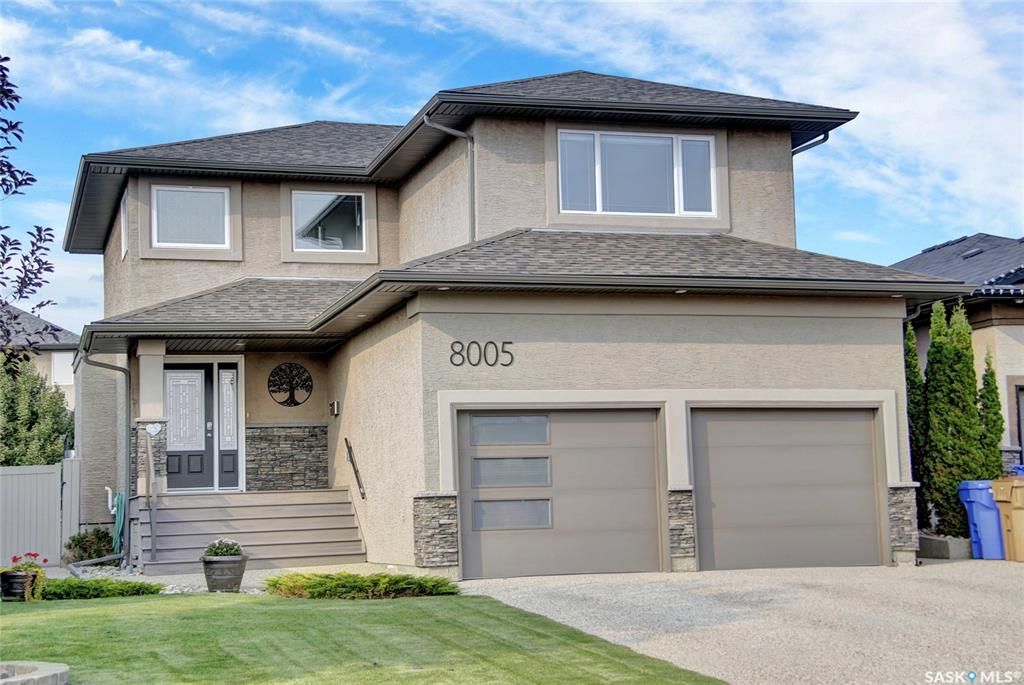 Welcome to 8005 Edgewater Bay! Stunning street appeal with triple exposed aggregate driveway and modern garage doors. Low maintenance exterior and newer front composite steps.