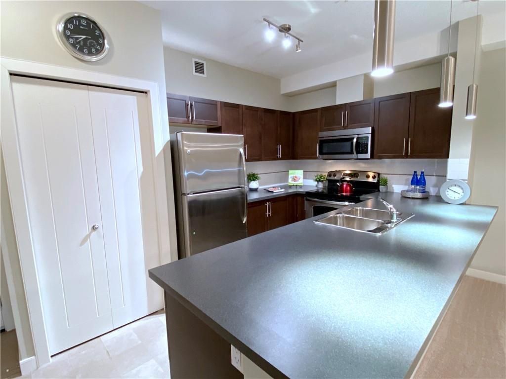 The unique layout of this 2 Bedroom condo allows for an extra large Kitchen...  This Breakfast Bar goes on for miles doesn't it?!