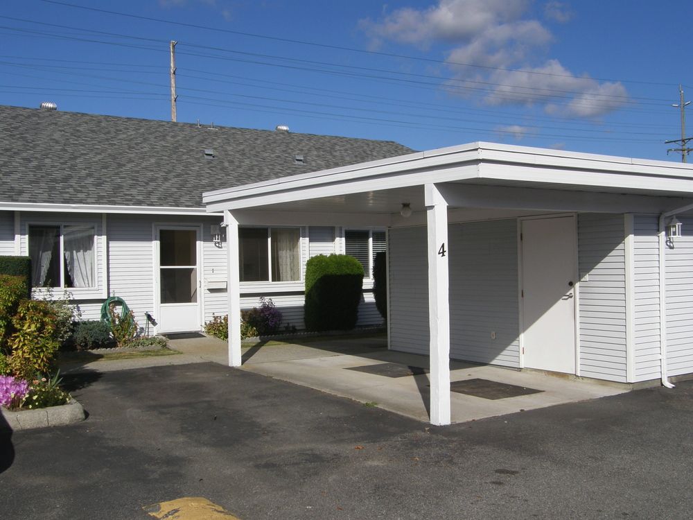 Front of unit showing carport and extra parking stall (included)