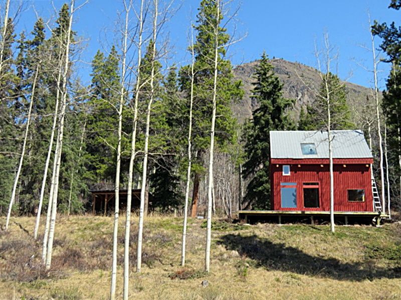 On a treed bench nestled at the base of Munroe Mountain, this home was built by the owner in 1978 from lodgepole pine, white spruce and black spruce all harvested from the property by the owner.  On a concrete foundation with lots of rebar this home is me