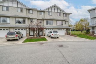Photo 1: 42 Crystal Shores Cove: Okotoks Row/Townhouse for sale : MLS®# A1218306