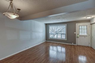Photo 3: 323 Queenston Heights SE in Calgary: Queensland Row/Townhouse for sale : MLS®# A1203860