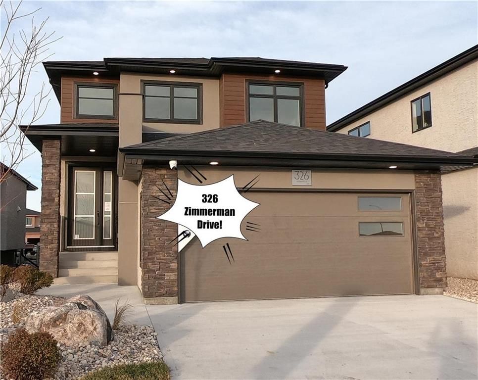 Welcome! Gorgeous curb appeal with lovely landscaping, wide front drive, beautiful stone work, covered front entry and the oversized 8' front door!