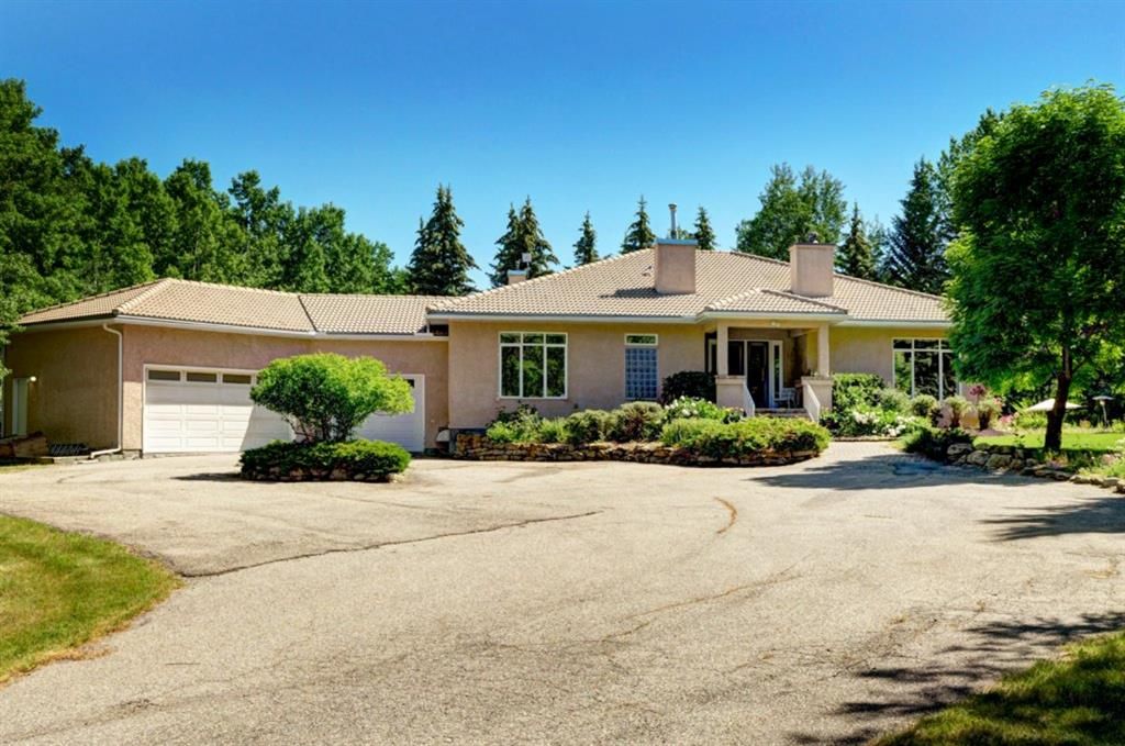 Large bungalow, stucco siding, tile roof, Huge 3 car garage, slate front entrance porch.. Professionally landscaped gardens with many native plants and wild flowers. 
  Also 3 very unique Black Ash Tree's that really make a statement.