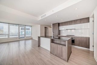 Photo 5: 401 51 Waterfront Mews SW in Calgary: Chinatown Apartment for sale : MLS®# A2118322