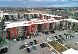Photo 1: 211 403 Mackenzie Way SW: Airdrie Apartment for sale : MLS®# A2125740
