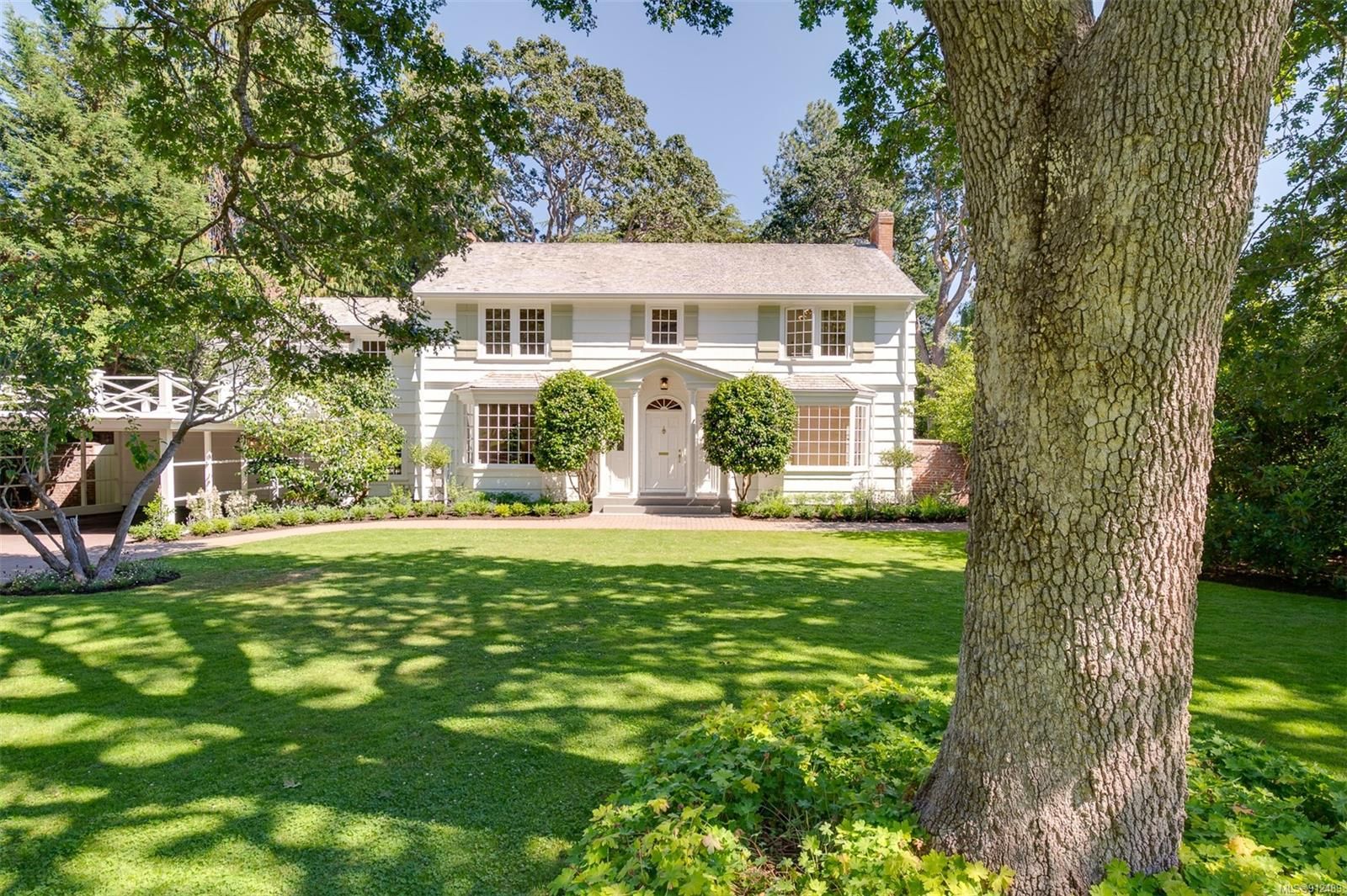 Classic Colonial Family Home on .49 acre garden. Rounded lavender plants add structure + sweetly scent the walkway. 3275 Uplands Road, Victoria BC V8R 6B8