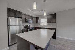 Photo 4: 405 Redstone View NE in Calgary: Redstone Row/Townhouse for sale : MLS®# A1224923