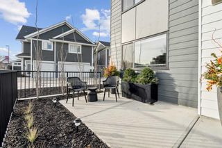Photo 3: 111 Dieppe Link SW in Calgary: Currie Barracks Row/Townhouse for sale : MLS®# A2106629