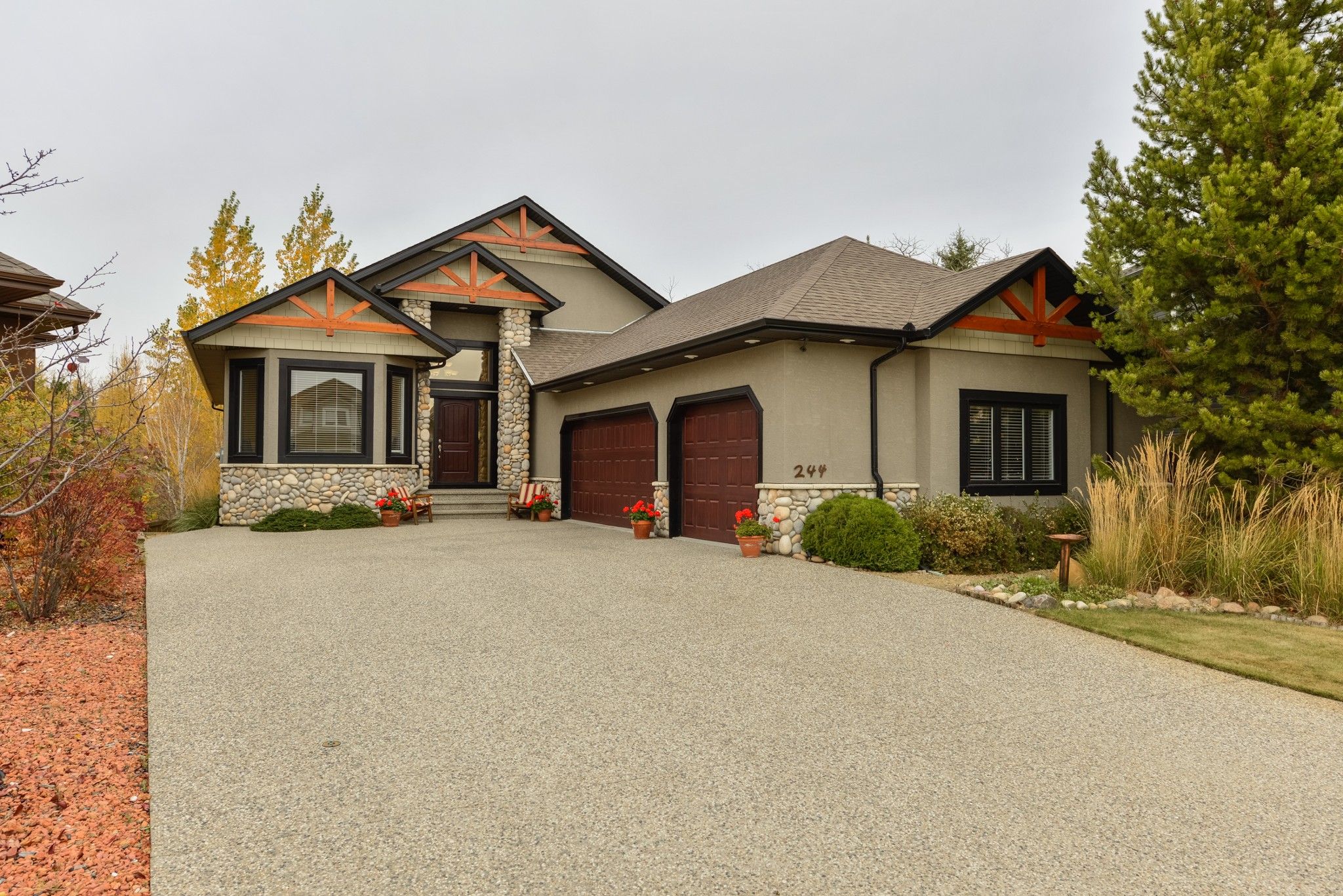 Architecturally designed with a 'Jasper' inspiration. Exterior finishings of stone, wood and acrylic. Oversized 3 car garage 23.2' x 38.8', heated with 60,000 BTU heater and dehumidifier. 30 year shingles. Exposed aggregate driveway,front steps and back p