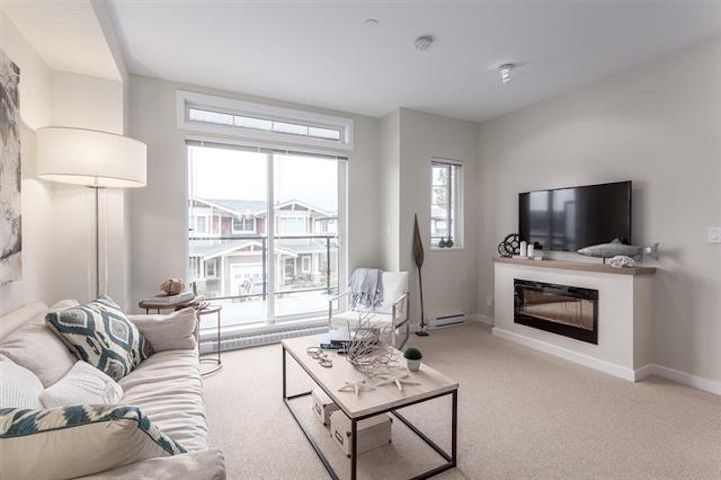 Enjoy over height ceilings, an electric fireplace and a balcony adjacent to the living room. Disclaimer: