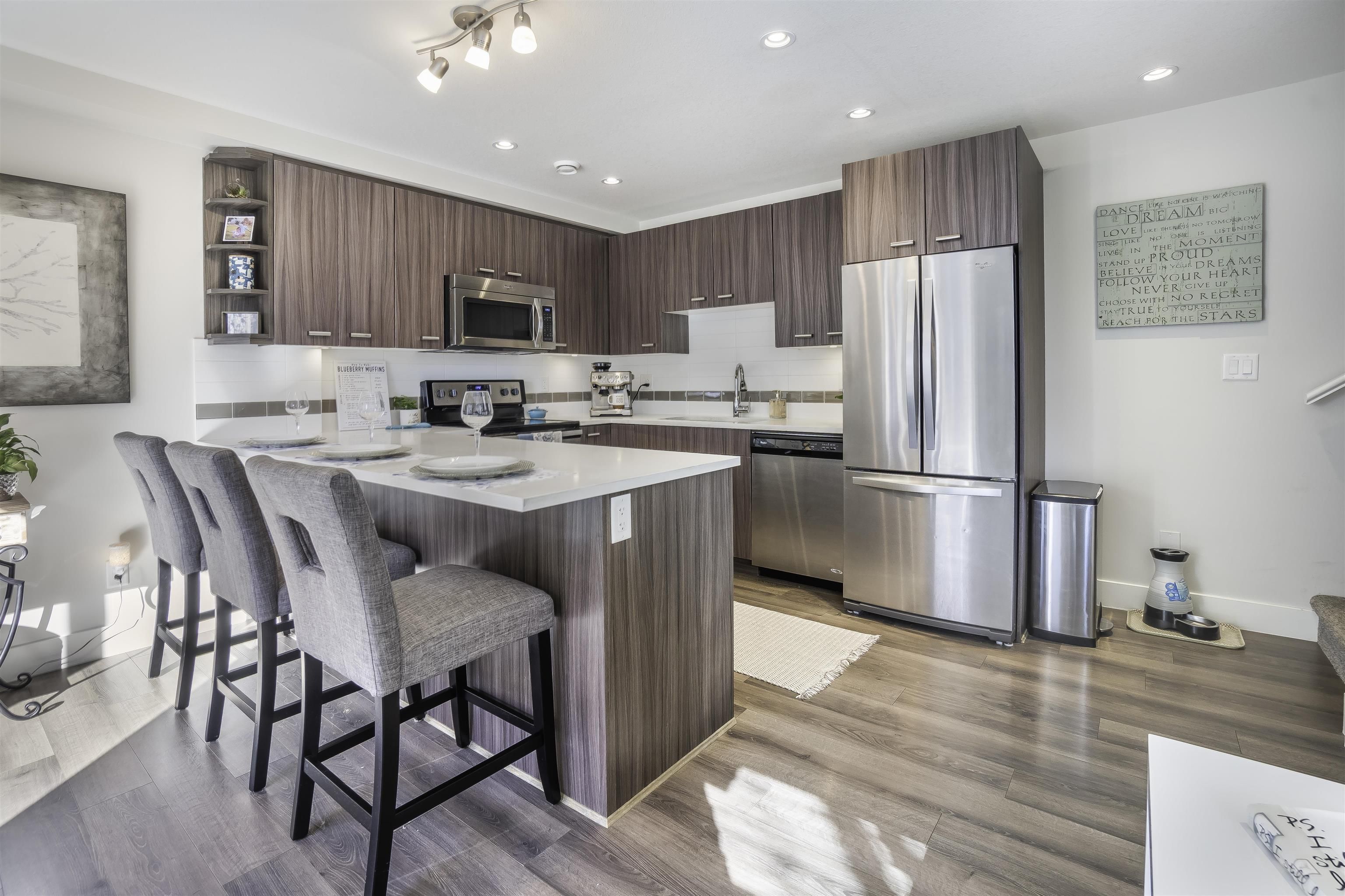 Oversized windows make this kitchen bright and enjoyable to be in! Stainless Steel Appliances, lots of cupboards and a great island for enjoying visiting with your guests while you cook!