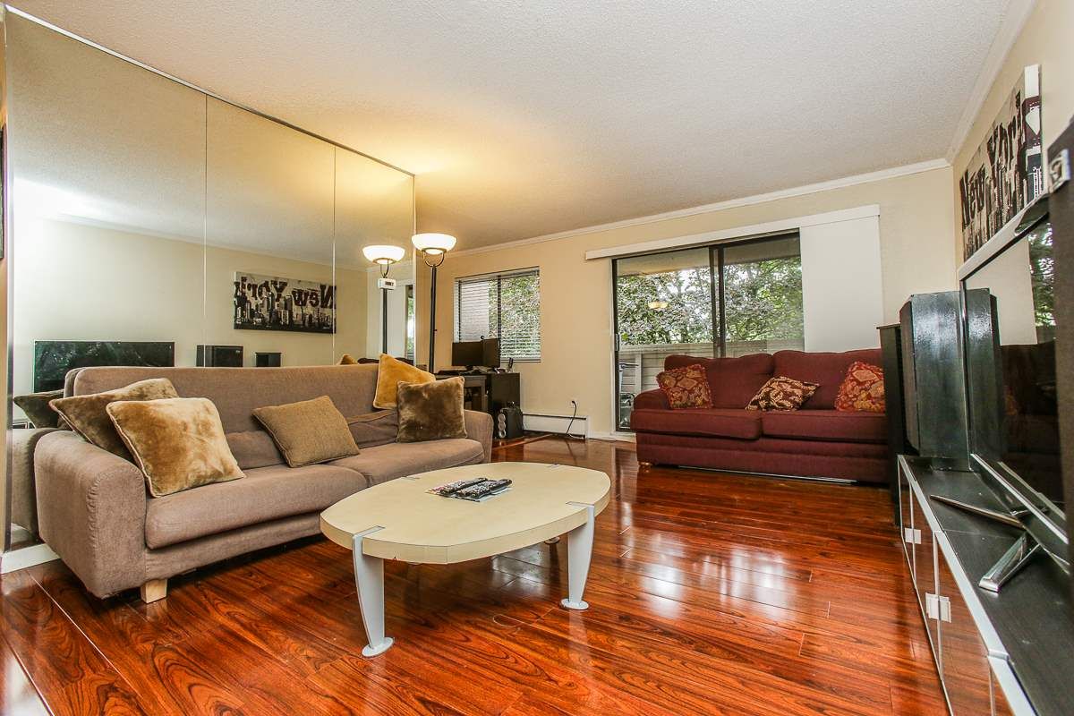 Extra large living room with gorgeous flooring and plenty of space for house sized furniture.  Sliding doors from the living room lead to large covered patio with lovely treed outlook.