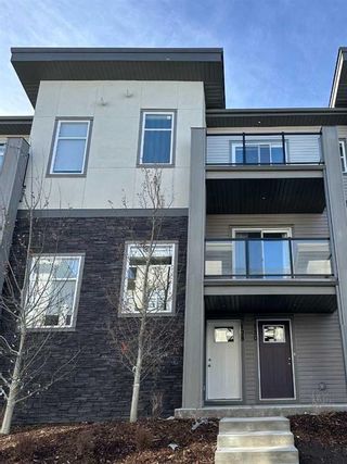 Photo 1: 128 Spring Creek Common SW in Calgary: Springbank Hill Row/Townhouse for sale : MLS®# A2109387