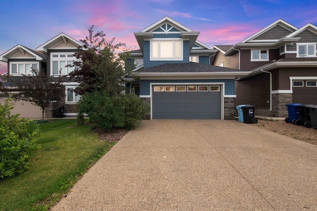 140 Dixon Road backing onto greenbelt with a double attached heated garage and aggregate driveway