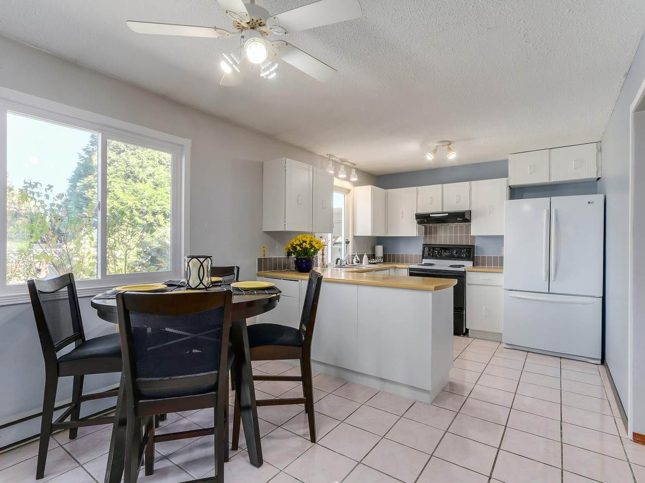 Great working kitchen with lots of counter space. Lots of space for eating area with big picture window looks out to fenced back yard.