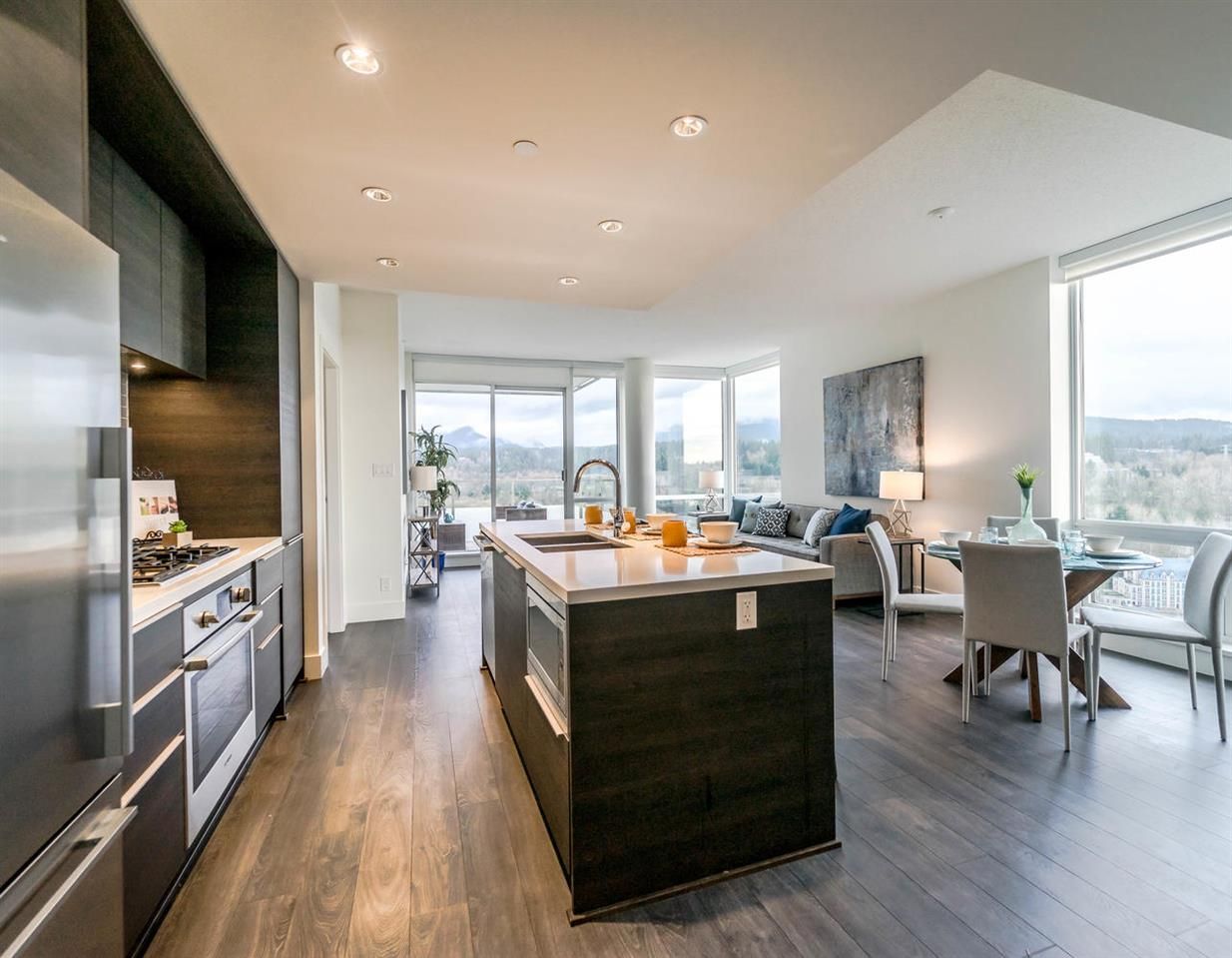 Open concept living space with floor-to-ceiling windows that have views from Grouse to Burnaby.