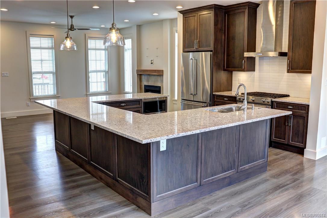 Quartz counters, high end appliances, wood cabinets with soft close feature.