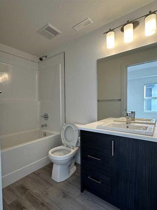 Photo 10: 128 Spring Creek Common SW in Calgary: Springbank Hill Row/Townhouse for sale : MLS®# A2109387
