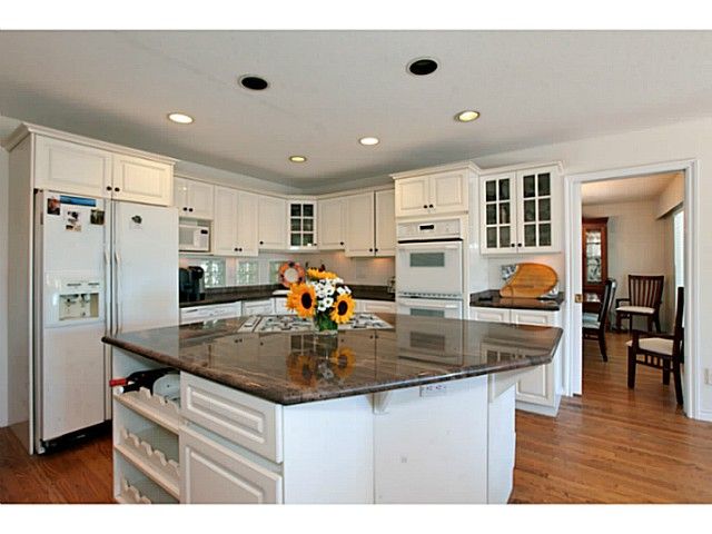 Bright white kitchen with double wall oven
