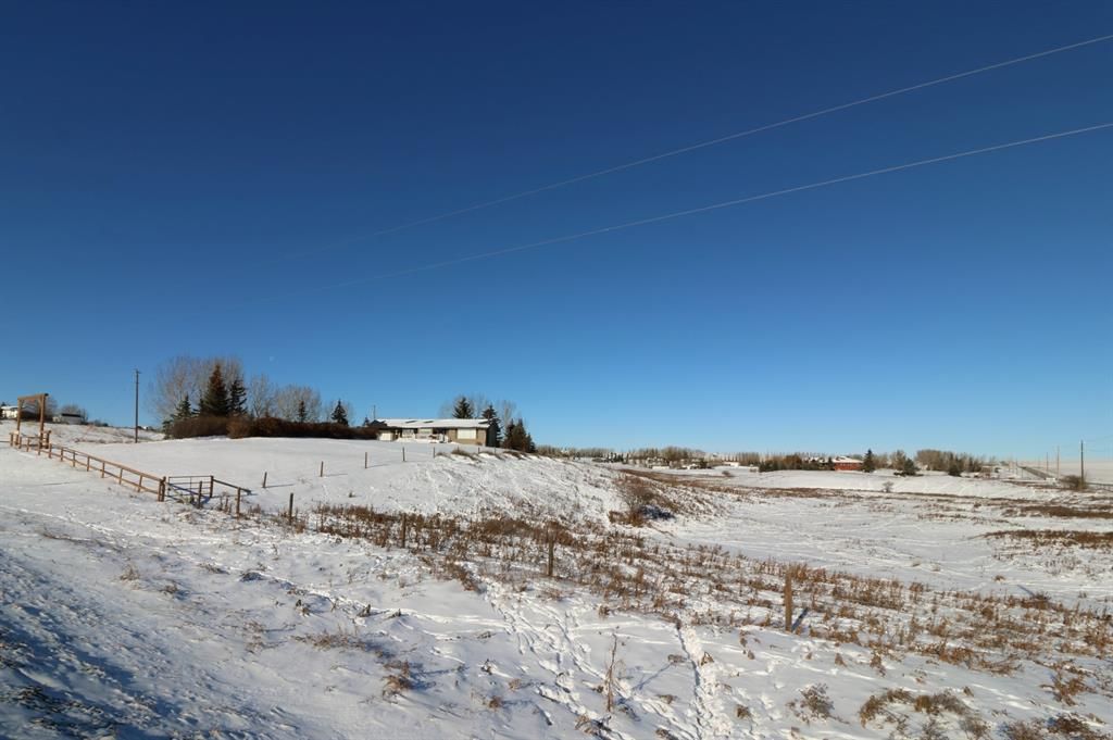 Now here’s a find, on pavement & Very close proximity to Airdrie & Calgary on 13+ acres. Larger bungalow (1375 sq. ft or 127.7 sq. m2) with a nice size South facing front deck and single attached garage.over the land & its seasonal creek.