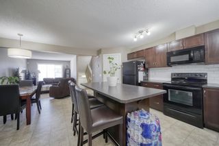 Photo 2: 555 Panatella Boulevard NW in Calgary: Panorama Hills Row/Townhouse for sale : MLS®# A2034434