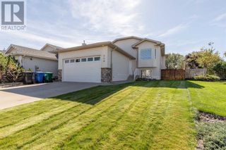 Photo 1: 110 Heritage Court W in Lethbridge: House for sale : MLS®# A2081300